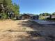 Charming single-story home featuring a gray exterior, white trim, and newly installed concrete driveway at 5411 Nw 7Th Pl, Ocala, FL 34482