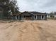 Charming new construction home with freshly painted gray siding, a black roof and white trim at 5411 Nw 7Th Pl, Ocala, FL 34482