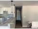 Open kitchen design with granite counters, pendant lighting, and wood-look floors at 5411 Nw 7Th Pl, Ocala, FL 34482