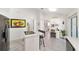 Modern kitchen with island, white cabinets, and view of the pool at 5503 Nw 25Th Loop, Ocala, FL 34482