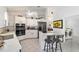 Modern kitchen with white cabinets, stainless steel appliances, and breakfast bar at 5503 Nw 25Th Loop, Ocala, FL 34482