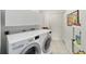 Convenient laundry room with washer, dryer, and overhead cabinets at 5503 Nw 25Th Loop, Ocala, FL 34482