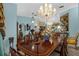 Bright dining room with a beautiful chandelier and large table at 5824 Sw 100Th Ln, Ocala, FL 34476