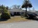 Single-story home with gray roof and landscaped yard at 5824 Sw 100Th Ln, Ocala, FL 34476