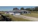 Gray house with a white garage door and gravel driveway at 630 Sw 210Th Ave, Dunnellon, FL 34431