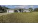 Single-story home with attached garage and yard at 630 Sw 210Th Ave, Dunnellon, FL 34431