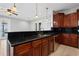 Kitchen with dark wood cabinets and granite countertops at 630 Sw 210Th Ave, Dunnellon, FL 34431