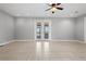 Bright living room with tile floors and French doors at 630 Sw 210Th Ave, Dunnellon, FL 34431