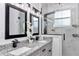 Stylish bathroom featuring a double sink vanity with granite countertops and a walk-in shower at 7646 Sw 129Th Pl, Ocala, FL 34473