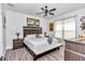 Comfortable bedroom with a ceiling fan, wood-look floors, and stylish decor at 7646 Sw 129Th Pl, Ocala, FL 34473