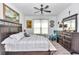 Bedroom showcasing a large bed, dresser, accent chair, and nautical-themed artwork at 7646 Sw 129Th Pl, Ocala, FL 34473