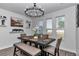 Elegant dining room featuring modern light fixture, seating for six, and decorative wall shelves at 7646 Sw 129Th Pl, Ocala, FL 34473