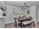 Dining area featuring a dark wood table and bench seating at 7646 Sw 129Th Pl, Ocala, FL 34473