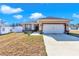 One-story home with attached garage, stone accents, and landscaping at 7646 Sw 129Th Pl, Ocala, FL 34473