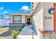 Inviting entryway with decorative rain chains, stone accents, and manicured landscaping at 7646 Sw 129Th Pl, Ocala, FL 34473