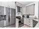 Modern kitchen featuring gray cabinets, stainless steel appliances, and granite countertops at 7646 Sw 129Th Pl, Ocala, FL 34473