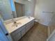 Double sink bathroom with shower and tile flooring at 8512 Sw 136Th Pl, Ocala, FL 34473