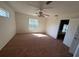 Spacious carpeted bedroom with ample natural light and ceiling fan at 8512 Sw 136Th Pl, Ocala, FL 34473