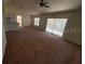 Open living room with access to backyard and carpet flooring at 8512 Sw 136Th Pl, Ocala, FL 34473