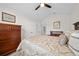 This bedroom features a ceiling fan, an ensuite bathroom, and neutral paint at 8822 Sw 108Th St, Ocala, FL 34481