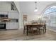 A dining room featuring wood floors, a table with six chairs, and a large window for natural light at 8822 Sw 108Th St, Ocala, FL 34481