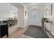 Welcoming foyer with decorative glass front door, high ceilings, and wood-look flooring at 8822 Sw 108Th St, Ocala, FL 34481