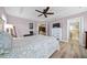 A spacious main bedroom featuring light wood floors and connecting bathroom at 8822 Sw 108Th St, Ocala, FL 34481