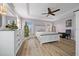 A bright main bedroom featuring light wood floors, a large window, and neutral decor at 8822 Sw 108Th St, Ocala, FL 34481