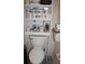 Toilet and storage shelving unit with bathroom supplies at 9662 Sw 97Th Ln, Ocala, FL 34481