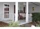 Relaxing front porch with white columns and seating at 9662 Sw 97Th Ln, Ocala, FL 34481