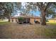 House exterior showcasing a screened patio and spacious backyard at 10090 Sw 78Th Ct, Ocala, FL 34476