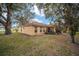 House exterior showcasing a screened patio and spacious backyard at 10090 Sw 78Th Ct, Ocala, FL 34476