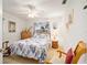 Cozy bedroom with a floral bedspread and ceiling fan at 10090 Sw 78Th Ct, Ocala, FL 34476