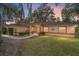 House exterior view at dusk, showing a walkway and landscaping at 10090 Sw 78Th Ct, Ocala, FL 34476