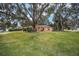 Ranch style home with large oak trees and lush lawn at 10090 Sw 78Th Ct, Ocala, FL 34476