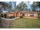 Front view of a single-story house with landscaping at 10090 Sw 78Th Ct, Ocala, FL 34476