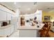 Bright eat-in kitchen with ample counter space and white cabinetry at 10090 Sw 78Th Ct, Ocala, FL 34476