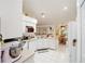 Inviting kitchen with white cabinets and a corner sink at 10090 Sw 78Th Ct, Ocala, FL 34476