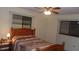 Bedroom with wood flooring, ceiling fan, and a double bed at 10470 Sw 99Th Ave, Ocala, FL 34481