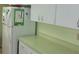 White kitchen cabinets and light green countertops with ample counter space at 10470 Sw 99Th Ave, Ocala, FL 34481