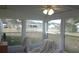 Bright sunroom with ample windows and ceiling fan at 10470 Sw 99Th Ave, Ocala, FL 34481