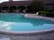 Kidney-shaped swimming pool with a surrounding patio at 10470 Sw 99Th Ave, Ocala, FL 34481