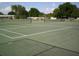 Two tennis courts with fencing and a seating area at 10470 Sw 99Th Ave, Ocala, FL 34481