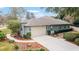 Attached garage with walkway and landscaping at 1105 Se 48Th Ave, Ocala, FL 34471