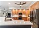 Modern kitchen featuring wood cabinets, quartz countertops, and stainless steel appliances at 1105 Se 48Th Ave, Ocala, FL 34471