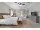 Main bedroom with king bed, carpet flooring, and plenty of natural light at 1105 Se 48Th Ave, Ocala, FL 34471