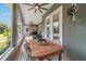 Outdoor dining area on a screened porch with backyard access at 1105 Se 48Th Ave, Ocala, FL 34471