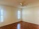 Bright bedroom featuring hardwood floors and plantation shutters at 11441 Sw 68Th Ct, Ocala, FL 34476