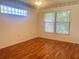 Bright bedroom with wood floors and window at 11441 Sw 68Th Ct, Ocala, FL 34476