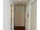 Light-colored hallway with wood flooring and access to multiple rooms at 11441 Sw 68Th Ct, Ocala, FL 34476